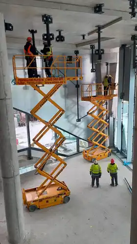 Nůžkové plošiny uvnitř rozestavěné budovy, Masaryk centrum Praha